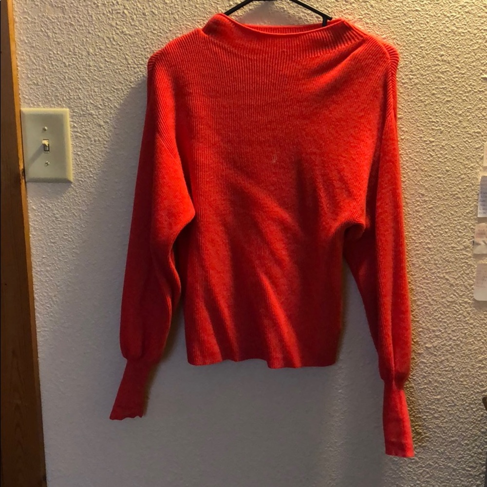 Cute red sweater.